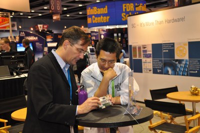 Dirk Pleiter (left) showing the BG/Q node card to a visitor from RIKEN