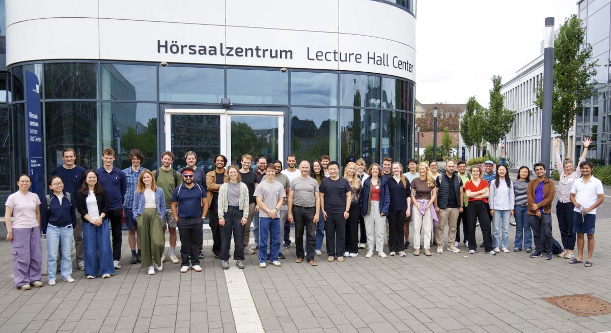 Several people are standing in front of a building with glass doors. (Mistral: Mistral Medium 3.5, 2026-09-07)
