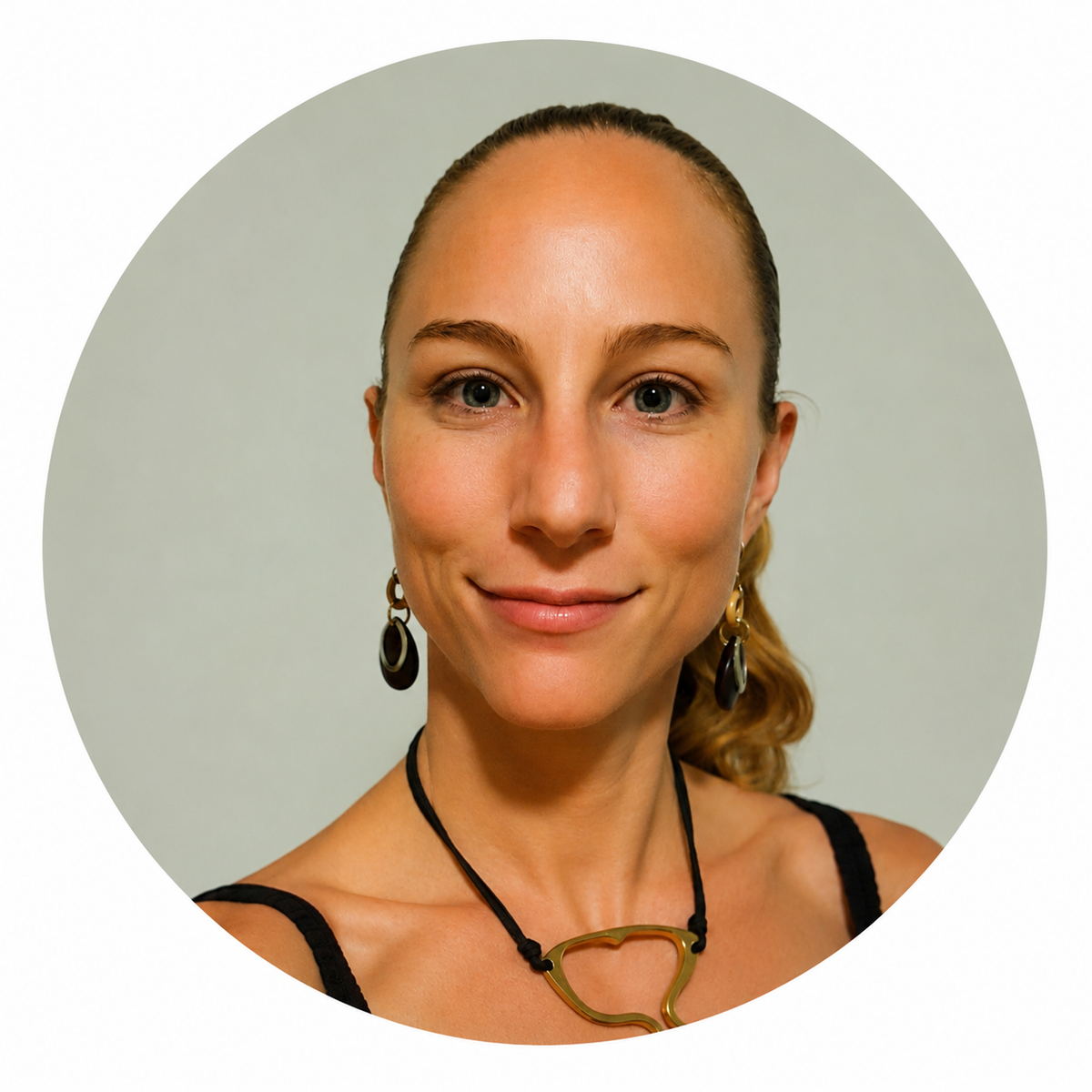 A person with short blonde hair tied back, wearing dark earrings and a necklace with a large pendant. (Mistral: Mistral Medium 3.5, 2026-09-07)